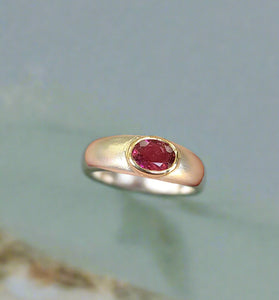bold pink tourmaline stone set in a 14k yellow gold bezel and band