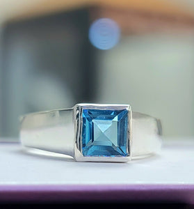 princess cute blue topaz encased in a sleek bezel and sterling silver