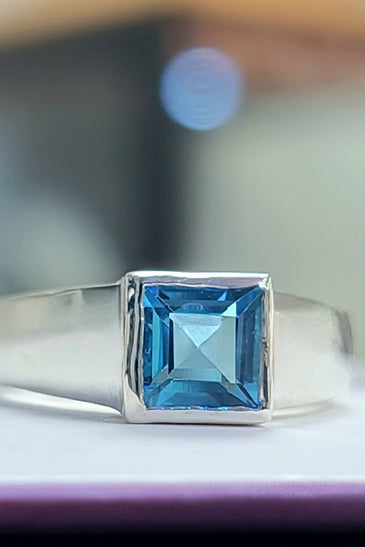 princess cute blue topaz encased in a sleek bezel and sterling silver