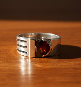 Sterling silver garnet ring with red gemstone and negative-space band detail