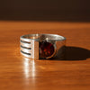 Sterling silver garnet ring with red gemstone and negative-space band detail
