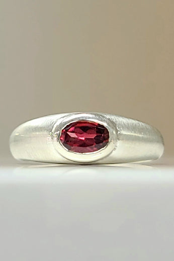 Sterling silver ring with oval red gemstone bezel set on rounded band