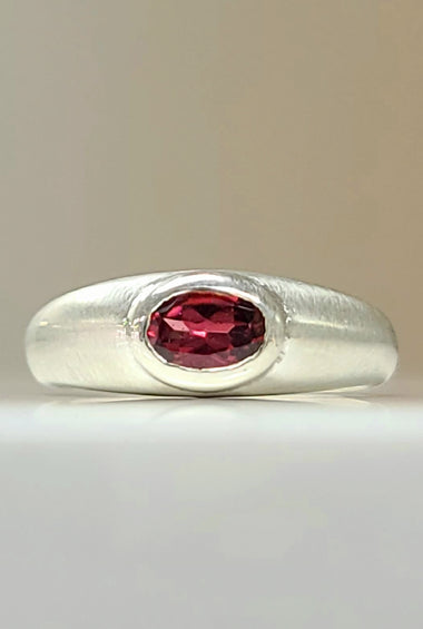 Sterling silver ring with oval red gemstone bezel set on rounded band