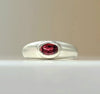 Sterling silver ring with oval red gemstone bezel set on rounded band