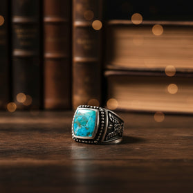 Turquoise-set sterling silver men’s ring, square bezel with patterned shank