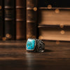 Turquoise-set sterling silver men’s ring, square bezel with patterned shank