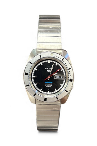 Stainless steel wristwatch with dark dial, red accents, and metal bracelet.
