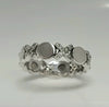 Sterling silver CZ ring with domed round centers and clustered small crystal stones