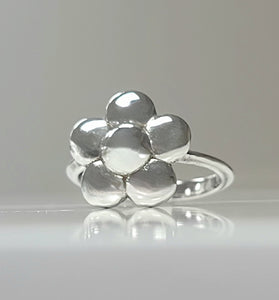 Sterling silver flower ring with polished rounded petals on a slim band