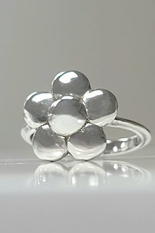 Sterling silver flower ring with polished rounded petals on a slim band