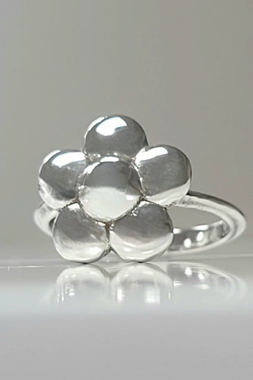 Sterling silver flower ring with polished rounded petals on a slim band