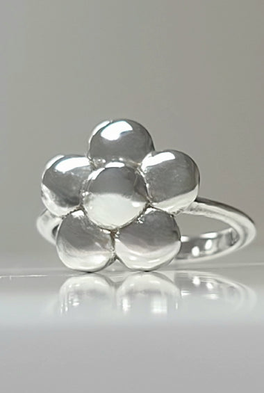 Sterling silver flower ring with polished rounded petals on a slim band