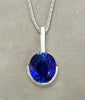 Sterling silver pendant with oval blue lab sapphire, half bezel, on chain