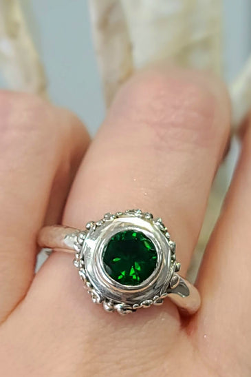 sterling silver ring with a round green quartz bezel