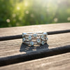 Sterling silver ring with round blue gemstones in a music-note style band