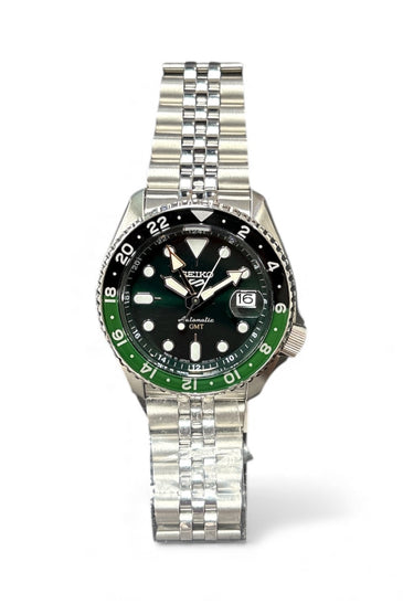 Stainless steel wristwatch with black dial, green bezel, and metal bracelet