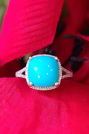 sleeping beauty turquoise surrounded by diamonds and sterling silver