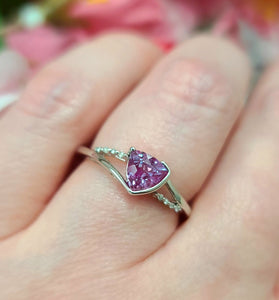 Alexandrite ring in white gold with purple oval gemstone and small green accents