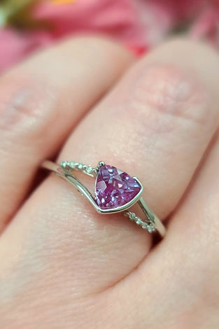 Alexandrite ring in white gold with purple oval gemstone and small green accents