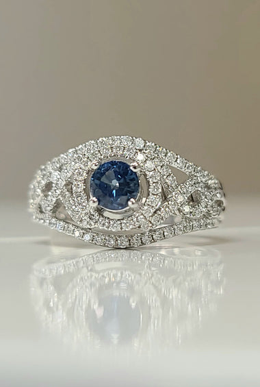 14kt white gold ring with round blue sapphire center and diamond halo, pavé details