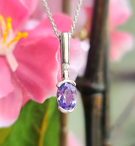 White gold tanzanite diamond pendant with oval purple gemstone and small diamond accents