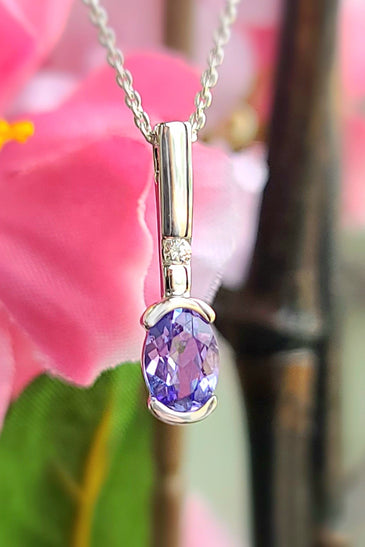 White gold tanzanite diamond pendant with oval purple gemstone and small diamond accents