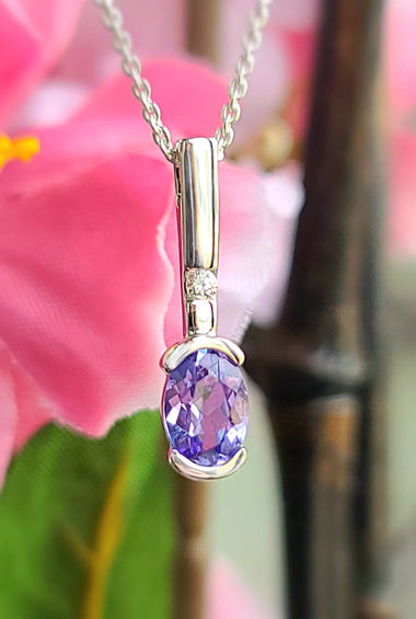 White gold tanzanite diamond pendant with oval purple gemstone and small diamond accents