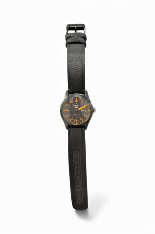 Seiko SRPH33 wristwatch with black fabric strap and dark round dial with orange accents