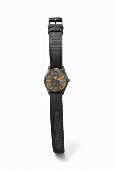 Seiko SRPH33 wristwatch with black fabric strap and dark round dial with orange accents