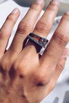 woman wearing asymmetrical ring, displaying a white topaz stone on the outer edge of a sterling silver ring