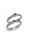 The garnet stone is set in intricately detailed sterling silver