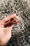 Woman holding two sterling silver rings with different colored stones