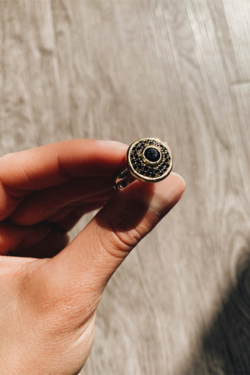 Elegant black zircon stone on gold plating centered on a smooth sterling silver band