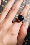 A dazzling black zircon stone is set in a sterling silver frame and band.