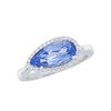 White gold ring: oval blue gemstone with diamond halo, slim band