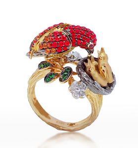 14kt yellow gold bird ring with red gemstone head, green stones, and white flower details