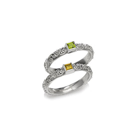 Sterling silver ring with ornate band and square green and yellow gemstones