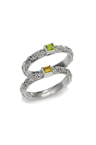 Sterling silver ring with ornate band and square green and yellow gemstones