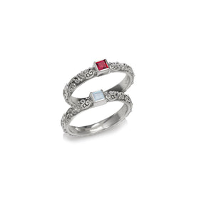 Sterling silver ring set with ornate filigree and two square gemstone insets, red and clear