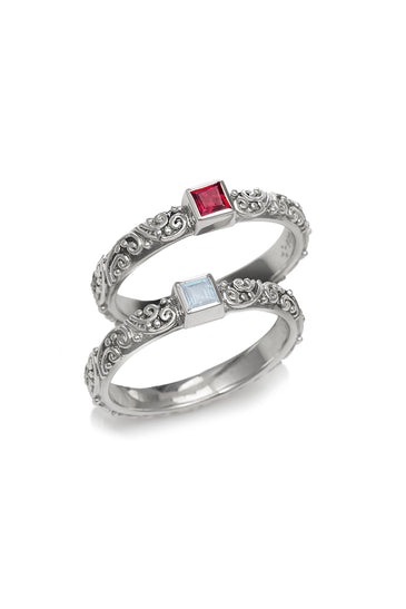 Sterling silver ring set with ornate filigree and two square gemstone insets, red and clear