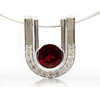 Sterling silver pendant with round red garnet and pave crescent frame
