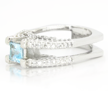 Sterling silver ring with square blue topaz and pavé stone bands