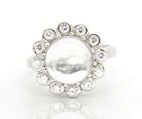 Sterling silver ring with white topaz cabochon and round halo of small stones
