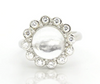 Sterling silver ring with white topaz cabochon and round halo of small stones