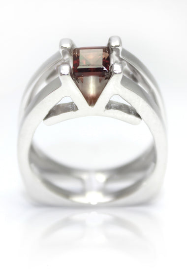 Sterling silver ring with garnet red square center stone and claw-set shoulders