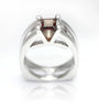 Sterling silver ring with garnet red square center stone and claw-set shoulders