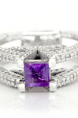 Regal princess cut amethyst adorned by white topaz on a sterling silver V ring