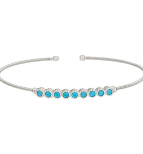 Sterling silver cuff bracelet with turquoise bead row and round end caps