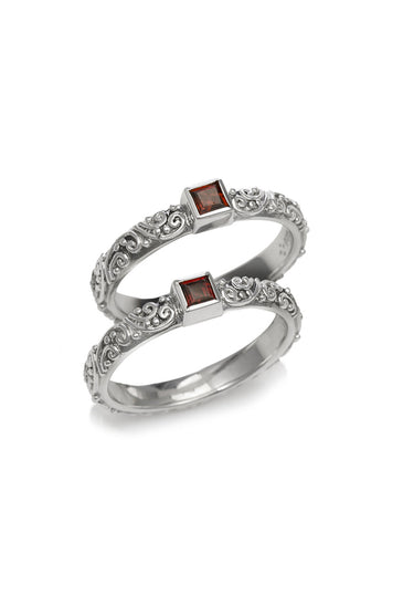 Sterling silver double-band ring with square garnet accents in geometric settings