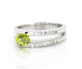 Sterling silver ring with oval peridot and clear pave sparkle bands